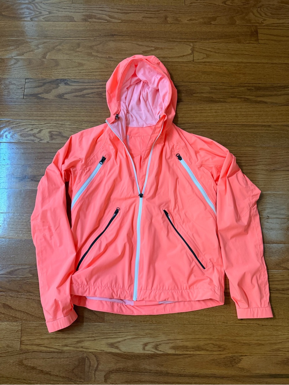 Lululemon Rise & Shine Jacket in a vibrant neon coral pink w/orange undertone